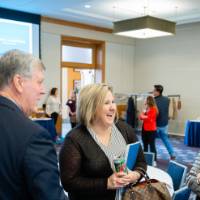 President Haas speaking with a group of people at the event.